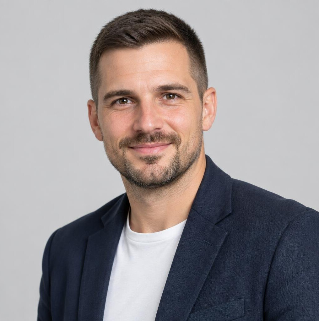 Portrait of a young man with short hair and a beard