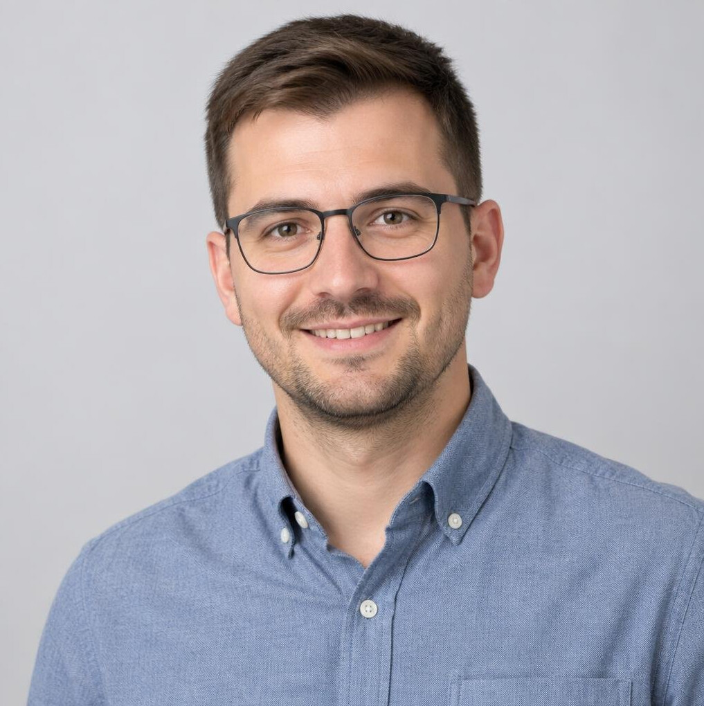 Portrait of a young man with glasses and a friendly smile